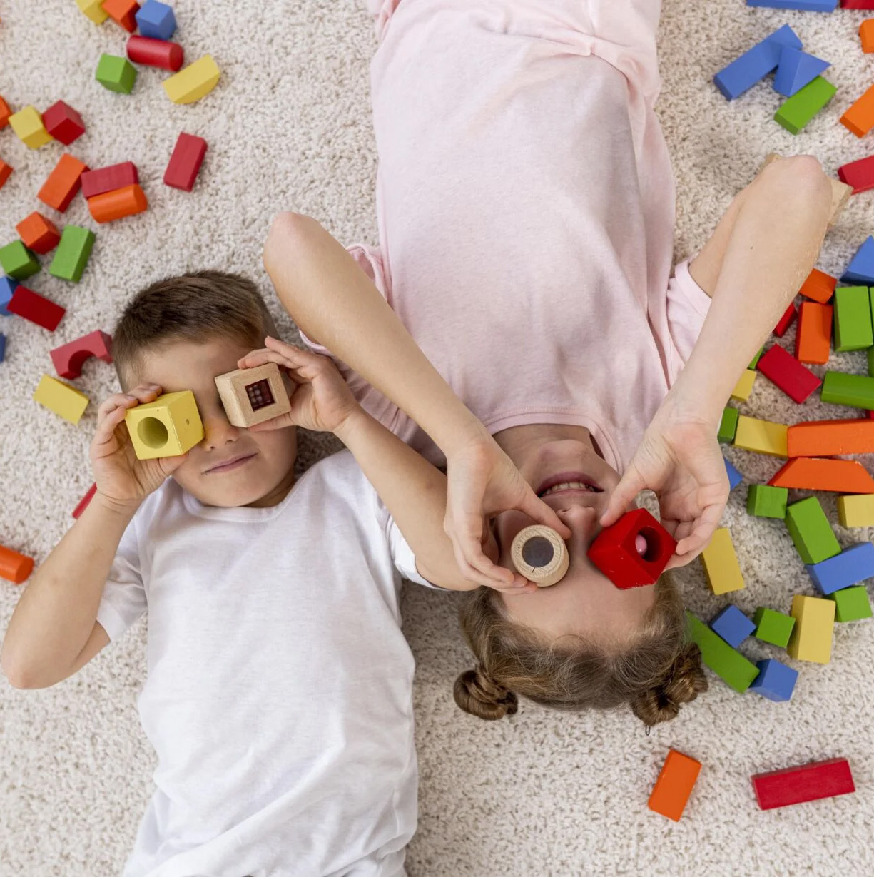 top-view-non-binary-kids-playing-with-colorful-game-1536x1229.jpg